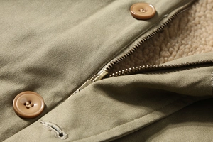 Detail of military green canvas jacket with warm sherpa lining and metal zipper