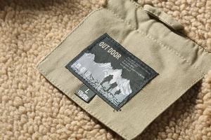 Detailed view of fleece lining and Outdoor brand label on men's winter jacket