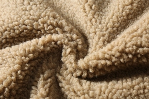 Close-up detail of soft camel faux shearling texture on men winter heavy jacket
