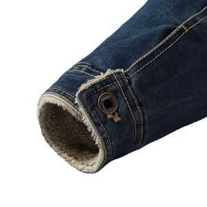 Men's dark blue denim jacket with thick white fleece lining and metal button cuff details
