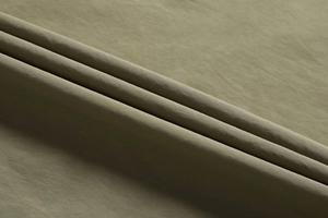 Close-up of military green outdoor vest featuring durable fine twill functional fabric