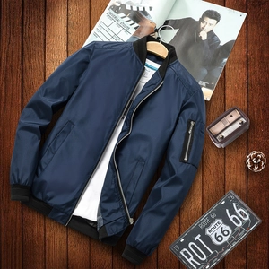 Classic navy blue men's bomber jacket with ribbed cuffs on a vintage wooden background