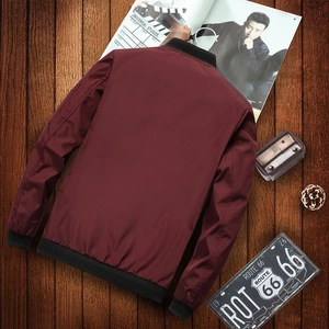Burgundy bomber jacket for men with black ribbed collar on vintage wood background