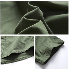 Detail of army green cotton fabric showing twill texture and reinforced double stitching