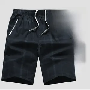 Detail of cotton shorts featuring elastic drawstring waist and zippered side pockets