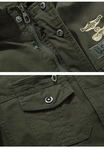 Detail of army green tactical jacket with embroidered U.S. badge and metal hardware