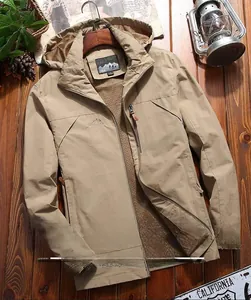 Detail of khaki windbreaker jacket with mountain logo embroidery on high-quality fabric