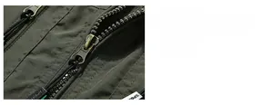 Detail of army green fishing vest with smooth metal zipper and sport puller strap