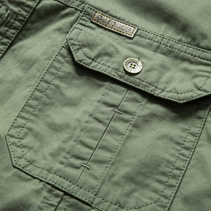 Military green cotton cargo shirt featuring a textured pocket with leather outdoor patch