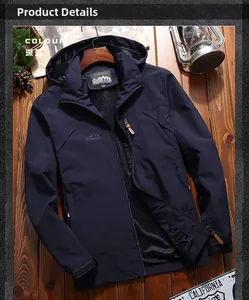 Detail of dark blue outdoor hooded jacket with zipper and white lettering on wood