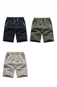 Detail view of plaid cotton shorts for men featuring elastic waist with drawstring and zippers