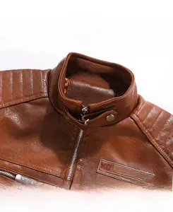Detail of brown faux leather jacket collar with quilting and metal zipper closure