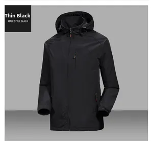Detail of male black windbreaker featuring zippered chest pocket and elastic cuffs