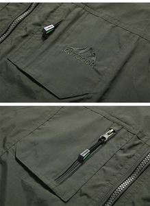 Detail of outdoor fishing vest showing reinforced pockets and embroidered mountain logo