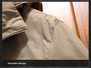 Detail view of khaki jacket shoulder design with durable stitching and windproof fabric