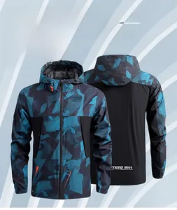 Detail of hooded outdoor windbreaker featuring blue geometric camouflage and waterproof fabric