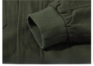 Detailed macro view of the olive green military jacket with ribbed elastic cuffs