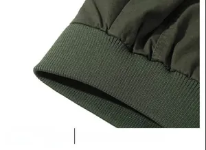 Detail of olive green cotton jacket showing the elastic ribbed hem for windproof fit