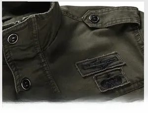 Detail of military style jacket collar with shoulder epaulettes and embroidered patches