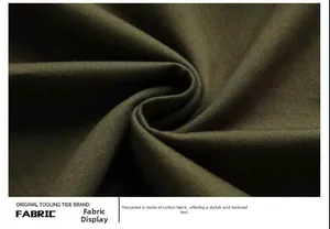 Detail of dark green cotton fabric texture and twill weave on a military jacket