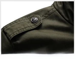 Close-up of military green men's jacket shoulder epaulette with twill fabric and button detail