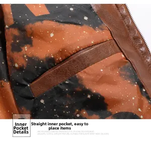 Detailed close-up of the brown faux leather jacket inner pocket with galaxy print lining