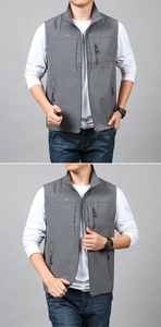 Detailed view of the stand-up collar and embroidered logo on this gray outdoor vest