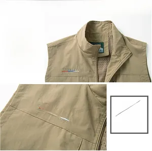 Detail of khaki outdoor vest showing embroidery and breathable mesh lining texture