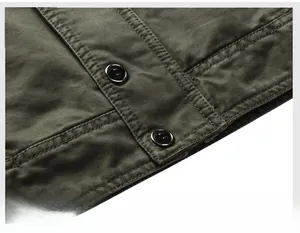 Detailed close-up of military green jacket placket with premium hardware buttons and metal trim
