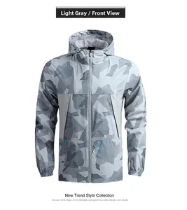 Front view of light grey outdoor windbreaker jacket with geometric patchwork and hood