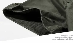 Detail of army green cotton shirt sleeve with metal button and fine double-line stitching