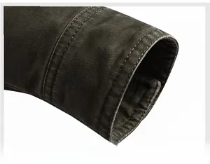 Close-up of durable canvas jacket cuff with double-stitched seams and rugged texture