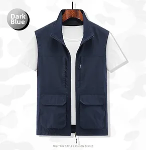 Detail of a dark blue multi-pocket fishing vest with zippers and military-style utility design