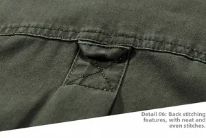Detailed close-up of olive green cargo shirt rear stitching and reinforced fabric loop