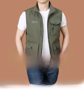 Detail showing army green multi-pocket outdoor vest with Freedom print on chest