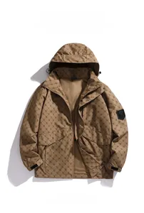 Detail of brown hooded outdoor jacket with all-over monogram pattern and sport sleeve badge