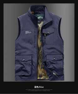 Detailed view of dark blue outdoor vest featuring multiple pockets and camouflage mesh lining