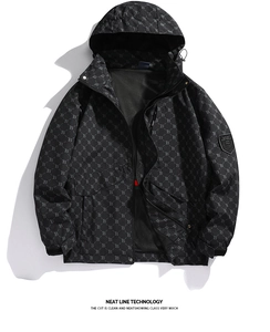 Detail of men's black outdoor jacket featuring monogram print and sport sleeve badge