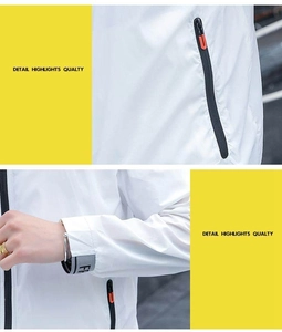Detail of white sun protection jacket showing zip pocket and adjustable velcro cuffs