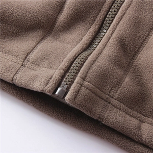 Macro shot of brown polar fleece jacket featuring smooth zipper and high-density stitching