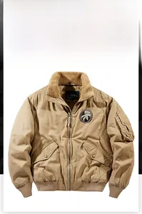 Detail of khaki bomber jacket with brown fleece collar and embroidered badge on chest