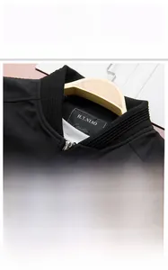 Detail of a black business casual jacket featuring ribbed collar and micro-twill fabric texture