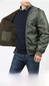 Detail of men's olive green jacket featuring a removable warm fleece lining and inner pocket