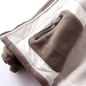 Close-up of heavy fleece jacket featuring a zipper pocket and white mesh lining