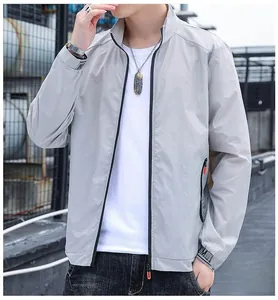 Detail of grey sun protection jacket showing zip-up stand collar and UM cuff embroidery