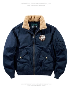 Detail of navy flight jacket with beige shearling collar and chest embroidery patch
