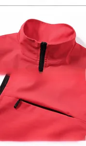Detail view of the red outdoor vest featuring a stand collar and secure zippered pockets