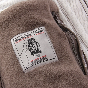 Detail view of brown fleece jacket showing mesh lining and performance brand label