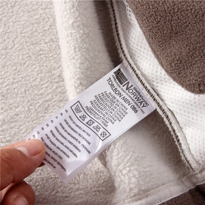 Detailed view of the wash care label on a warm fleece-lined outdoor jacket for men