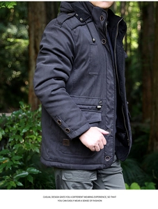 Outdoor close-up of a men's casual hooded jacket with utility pockets and metal buttons